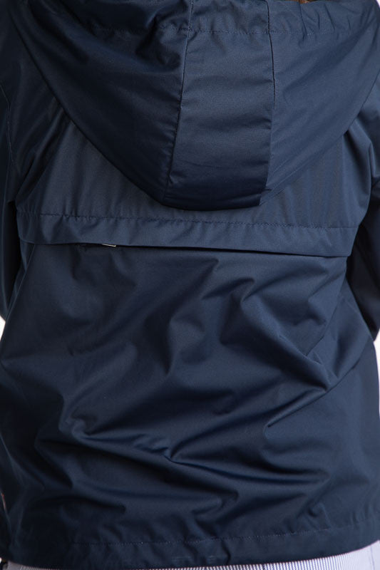 Close full back view of the hood on the Pack and Play Lightweight Golf Jacket in Navy Blue. This jacket folds into a pouch that easily fits in your golf bag.