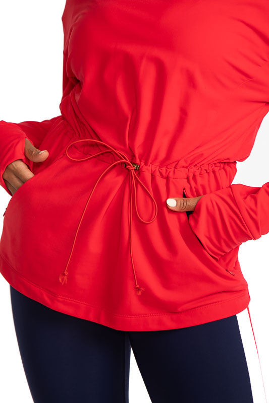 Close front view of the drawstrings and pockets on the Apres 18 Anorak Long Sleeve Hoodie in Watermelon Red.