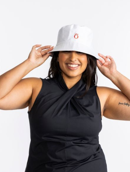 Smiling woman wearing the KINONA Big O Bucket Hat in white. Women's Golf Hat Holiday Giveaway: Purchase $150.00 or more now through December 31, 2022 and receive this bucket hat free (valued at $35).