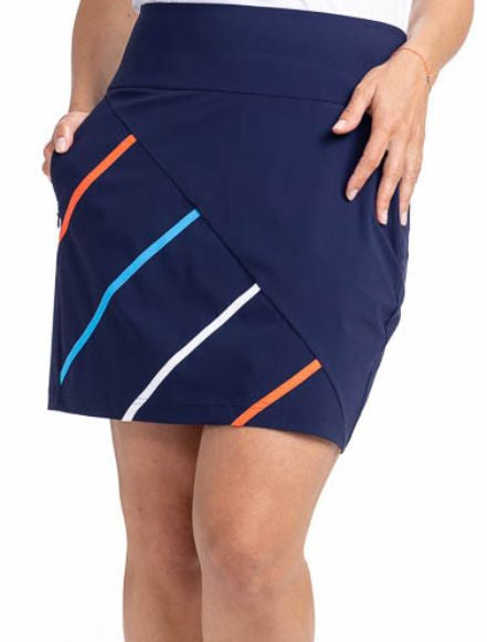 Front view of the Straight Drive Golf Skort in Navy Blue. This is a solid navy blue skort with four diagonal stripes on the front that run from the hemline approximately half the width in coral red, pacific blue, white, and coral red. 