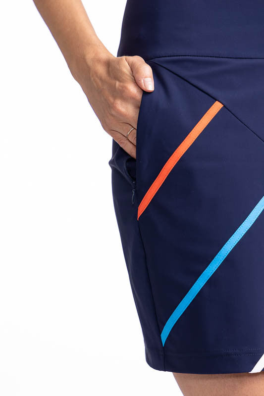 Close front and right side view of the in-seam pocket and two of the four front diagonal stripes on the Straight Drive Golf Skort in Navy Blue. This is a solid navy blue skort with four diagonal stripes on the front that run from the hemline approximately