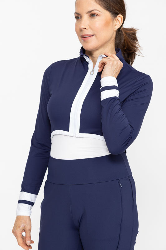 Front view of a woman wearing a Sun's Out Zip Front Shrug in Navy Blue zipped up