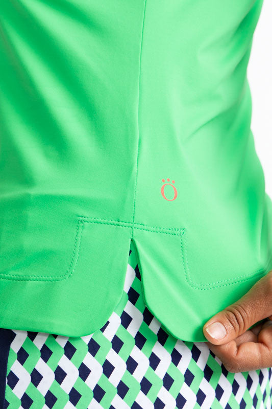 Close left side view of the hemline on the Victory Sleeveless Golf Top in Kelly Green