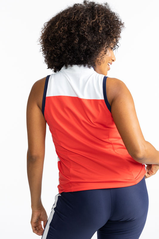 Back view of the Resolution Sleeveless Golf Top in Tomato Red. This top has a white section at the top front and back of this top, as well as a wide, white stripe with a thin, navy blue stripe in the middle of the stripe on each side of the shirt. There a