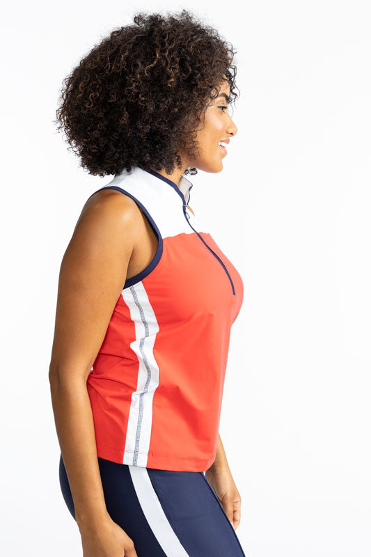 Right side view of the Resolution Sleeveless Golf Top in Tomato Red. This top has a white section at the top front and back of this top, as well as a wide, white stripe with a thin, navy blue stripe in the middle of the stripe on each side of the shirt. T