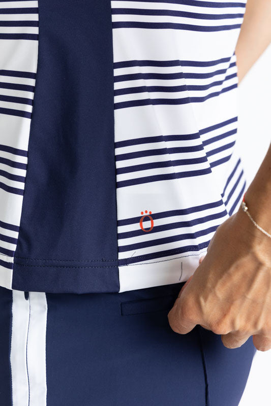 Close left side view of the hemline on the Cap to Tap Short Sleeve Golf Top in Shutter Stripe. This shirt has solid navy blue triangles on each shoulder as well as a solid navy blue section on each side of this top along with horizontal stripes in grouped