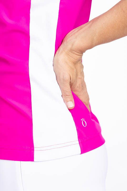 Close left side view of the stretch rib sides in white on the Cap to Tap Sleeveless Golf Top in Open Air Pink. This is a bright pink top with white sections on each shoulder and down each side. This top features a front quarter zipper, raglan cap sleeves,