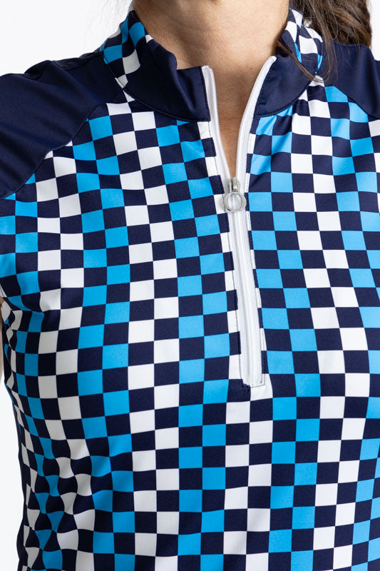 Close front view of the Cap to Tap Short Sleeve Golf Top in Check It Out Print. This print is a mix of French blue, black, and white checks forming a vertical striped pattern. This top features cap sleeves that are solid navy blue, white trim around each 