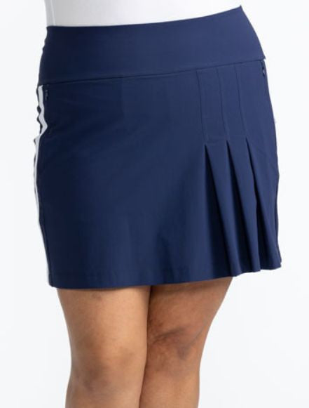 Close front view of the Party Pleat Golf Skort in Navy Blue. This skort has a solid, white stripe that runs down each side of this skort. 