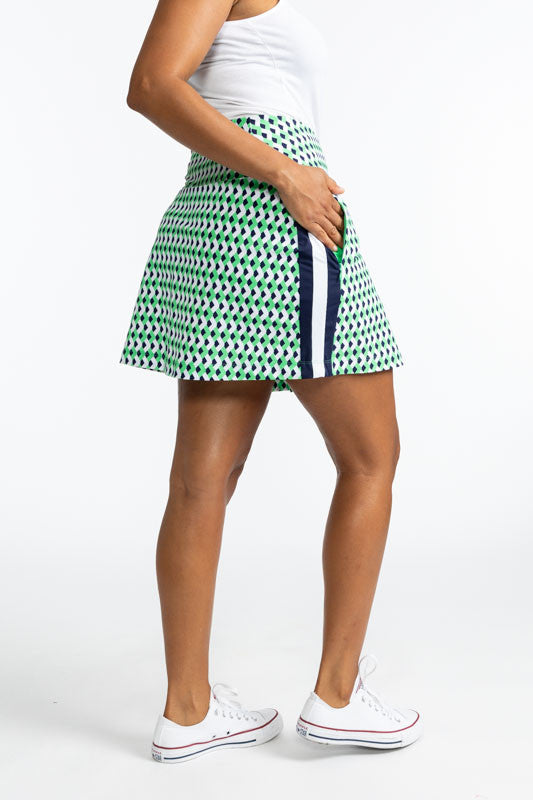 Right side view of the Party Pleat Golf Skort in Chevron Kelly Green. This skort has a wide, solid navy blue stripe with a white stripe running down the middle of the navy blue stripe on both sides.