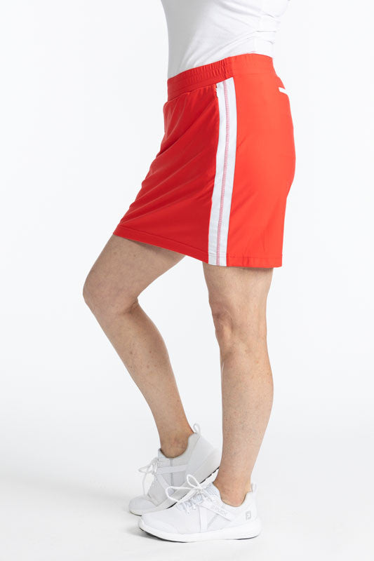 Left side view of the Seat Warmer Golf Skort in Tomato Red