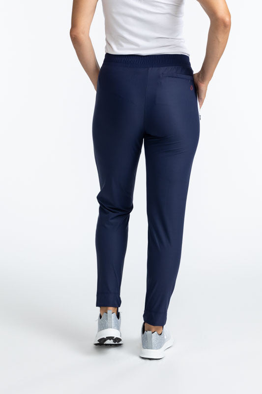 Back view of the Ankle Warmer Stirrup Pants in Navy Blue. These pants have a white stripe that runs down each side of the pants.