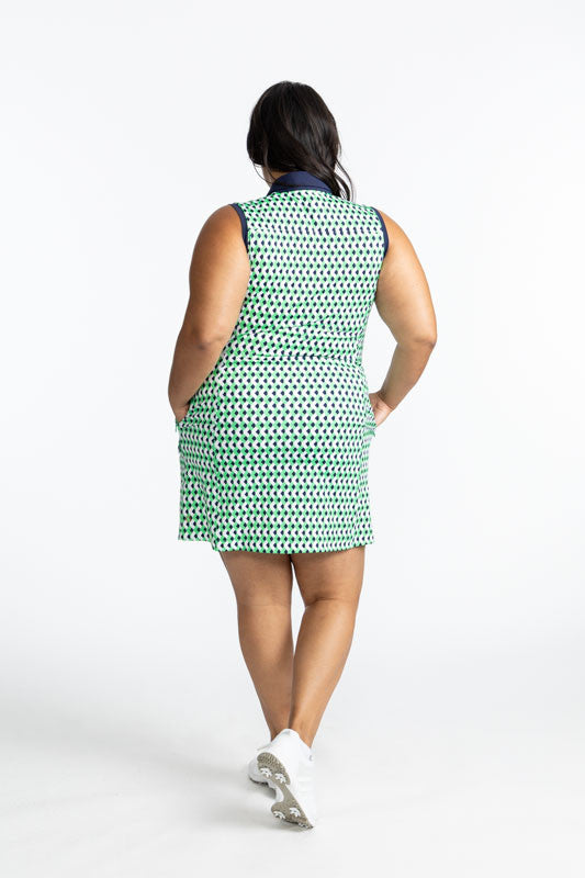 Full back view of the Resolution Sleeveless Golf Dress in Chevron Kelly Green. This dress has a navy blue collar and zipper that runs the length on the front of the dress and navy blue accents around each armhole.