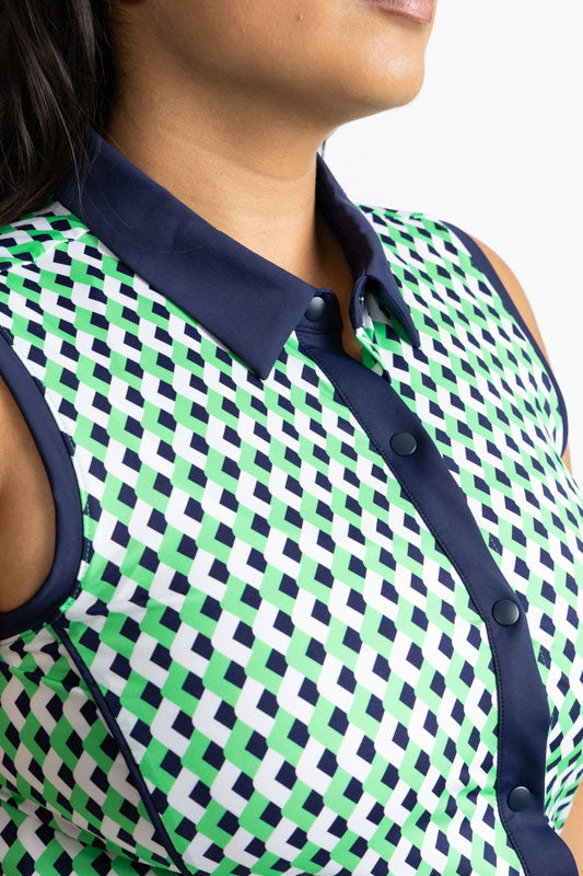 Close front and right side view of the neckline on the Resolution Sleeveless Golf Dress in Chevron Kelly Green. This dress has a navy blue collar and zipper that runs the length on the front of the dress and navy blue accents around each armhole.