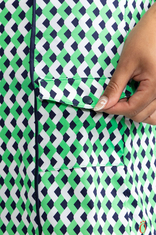Close right side view of the pocket on the Resolution Sleeveless Golf Dress in Chevron Kelly Green. In this view, you can see the pocket with flap and snap on the front of this dress.