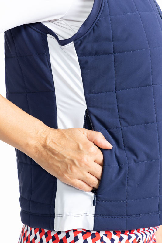 Close right side view of the pocket on the Chill Layer Golf Vest in Navy Blue. In this view, you can see the solid white stripe that runs down each side of the vest. 