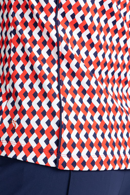 Close left side view of the hemline on the Dew Sweeper Sleeveless Golf Top in Chevron Tomato Red
