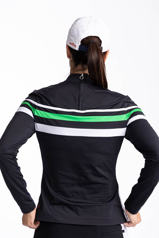 Back view of the Winter Rules Long Sleeve Golf Top in Black and the We've Got You Covered Hat in White. This top features three alternating stripes of white, rye grass green, and white stripes on a black long sleeve top with one white stripe down each sid