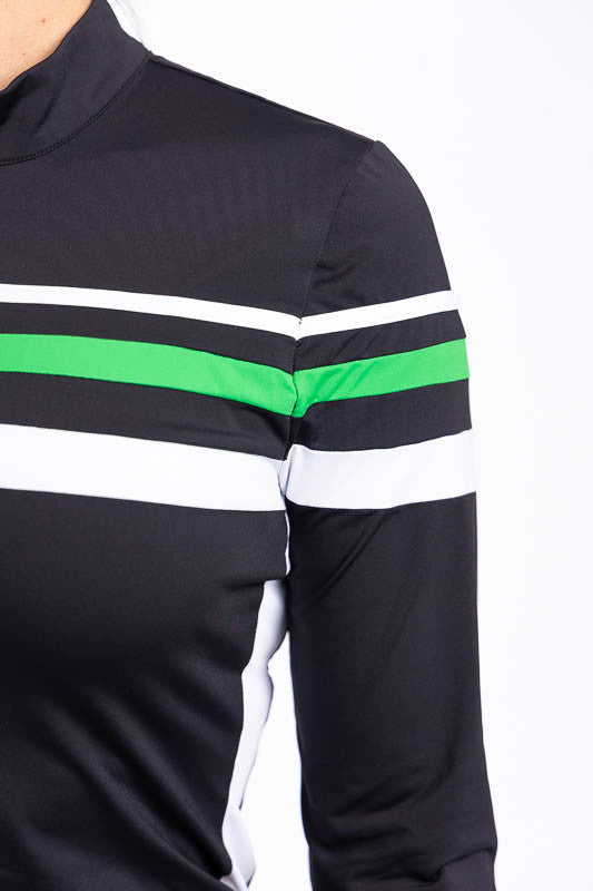 Close left side view of the stripes across the Winter Rules Long Sleeve Golf Top in Black and the We've Got You Covered Hat in White. This top features three alternating stripes of white, rye grass green, and white stripes on a black long sleeve top with 