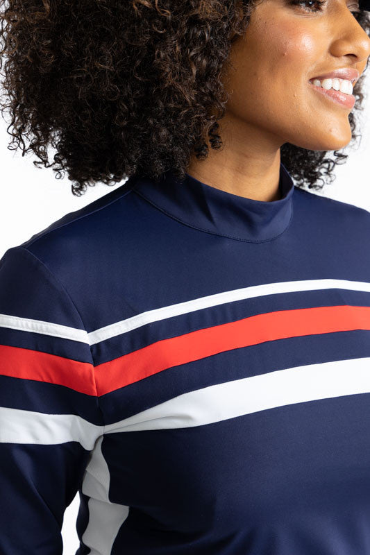 Close front view of the neckline on the Winter Rules Long Sleeve Golf Top in Navy Blue. In this view, you can see the pattern of the 360 degree stripe pattern across the chest area. First, a thin, white stripe with a navy blue spacer, then a thicker, soli