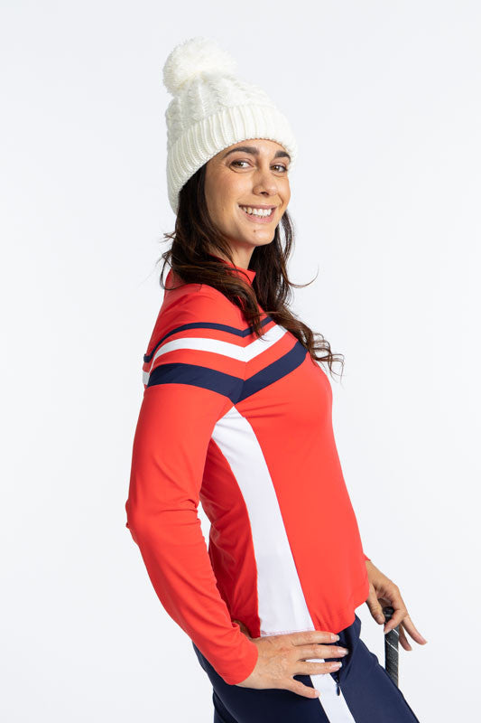 Right side view of the Winter Rules Long Sleeve Golf Top in Tomato Red. This top is primarily tomato red with a 360 degree pattern of lines across the chest area. A thin, navy blue stripe followed by a spacer of tomato red, then a thicker, solid white str