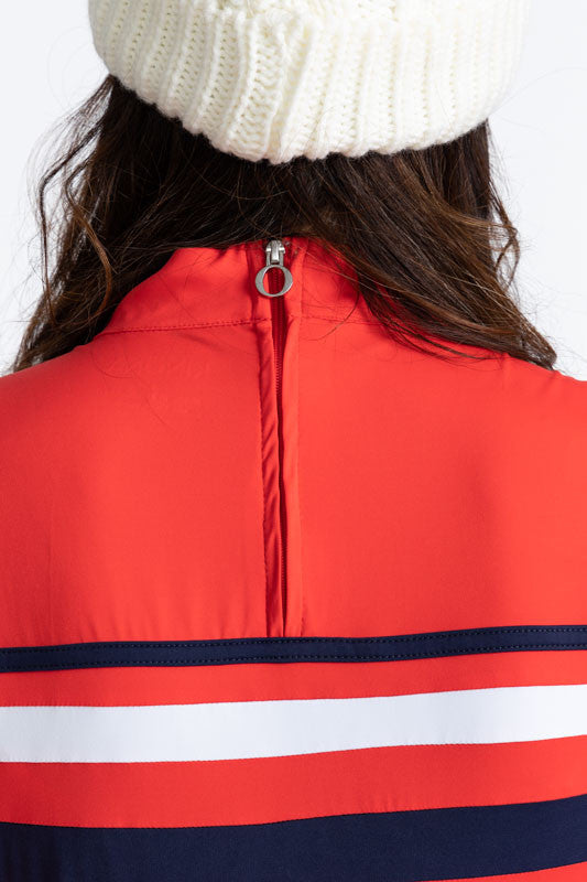 Close back view of the zipper on the Winter Rules Long Sleeve Golf Top in Tomato Red. In this view you can see the tomato red zipper on the back and the striped patter that runs around this top.