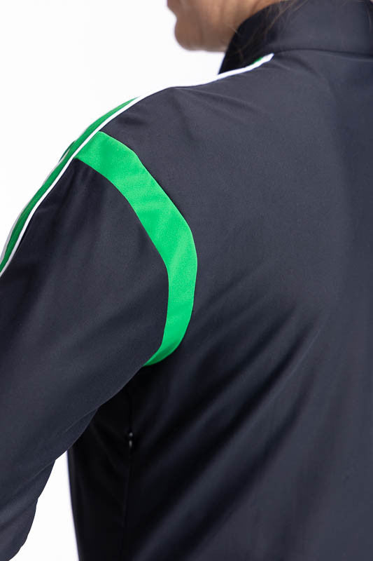 Close back left view of the rye green band just below the shoulder on the Warm Up Jacket in Black. This jacket has a rye green band around each arm just below the shoulder and three rye green stripes down each arm.