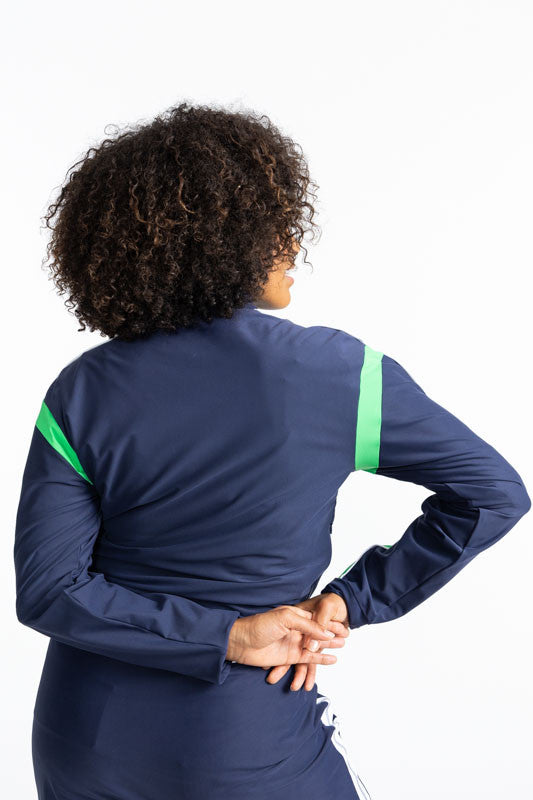 Back view of the Warm Up Jacket in Navy Blue. This jacket is primarily navy blue with a white zipper that runs down the front of this jacket. There is also a Kelly Green stripe that runs around each armhole and a solid Kelly Green stripe with a solid, thi