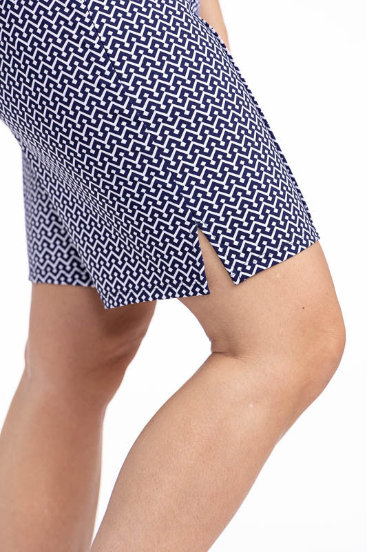 Close right side view of the hemline on the Golf Glove Friendly Golf Shorts in Chic Chevron print. This print consists of white chevrons on a navy blue background.
