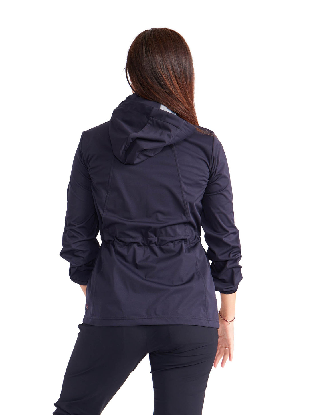 Back view of woman wearing black hooded golf rain jacket with cinch and black golf pants