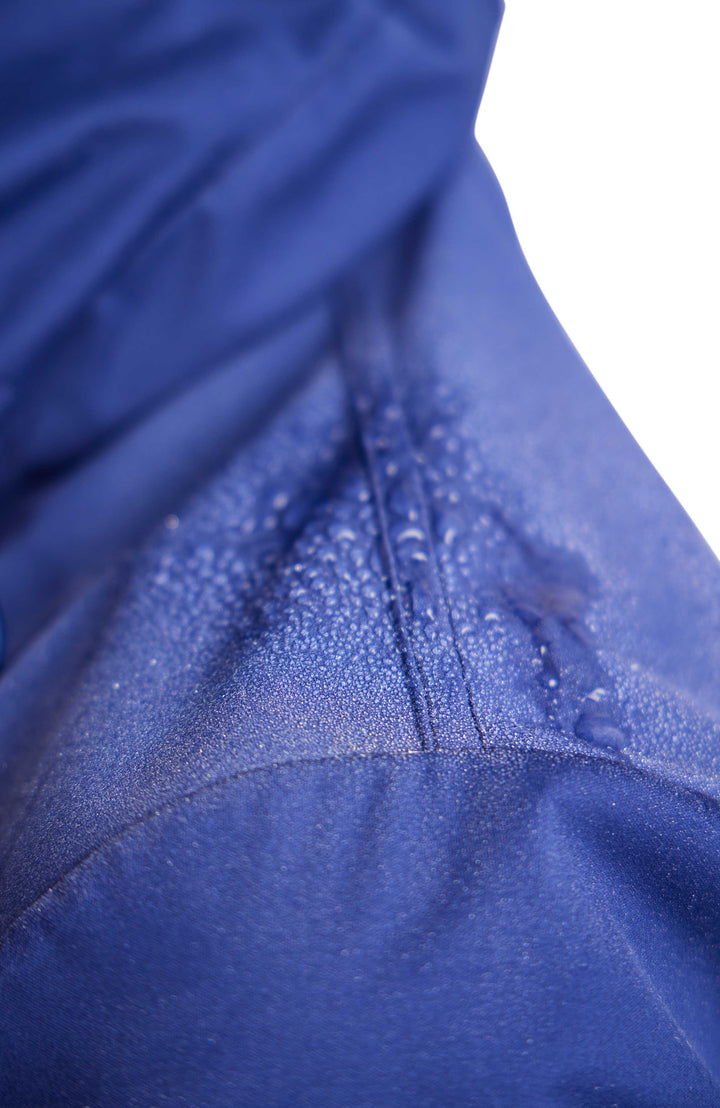 Close, detailed image of water sitting on top of the water repellent fabric. 