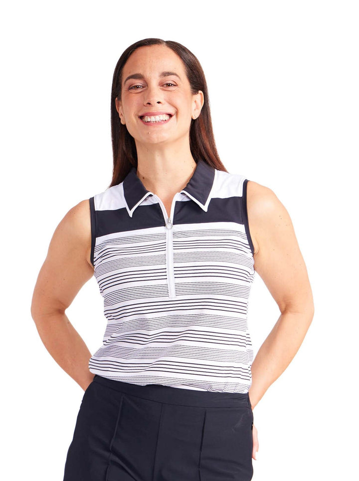 Front view of woman wearing white with black horizontal stripes, 1/4 zip, sleeveless top with collar.  Collar is black with white trim. Upper chest black stripe thicker than rest of shirt.