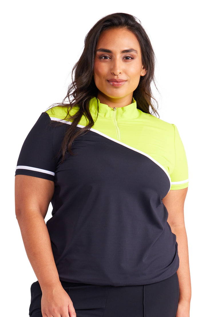 Front facing view of woman in a black and chartreuse short sleeve 1/4 zip mock neck top. Top has diagonal thin white stripe across chest and trim of sleeves