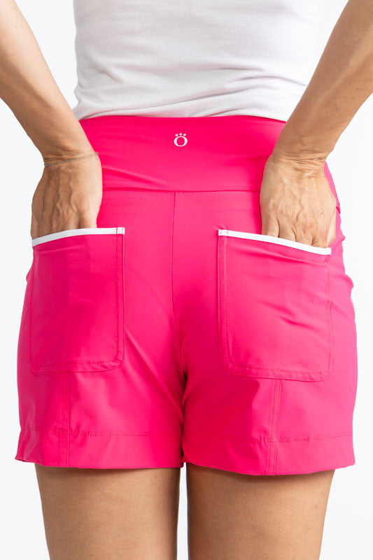 Close back view of the two back pockets on the Carry My Cargo Shorts in Preppy Pink. These are solid pink shorts with white trim on the two side and back pockets.