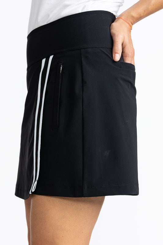 Close left side view of the Skort and Short Golf Skort in Black. This is a solid black skort with two thin, white stripes that run down the front of the split on the skirt portion of the skort.
