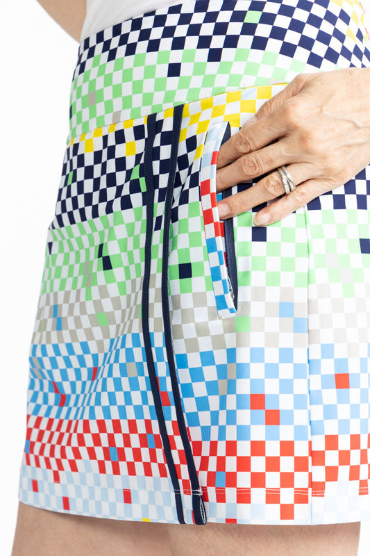 Close left side view showing one of the two side pockets on the Skort and Short Golf Skort in Cheeky Check print. This print is made up of a checked horizontal patter that creates a horizontal wrap in black, grass green, lemon yellow, French blue, and tom