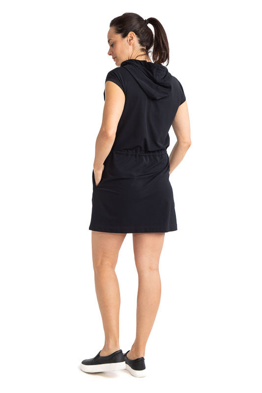 Back view of the Apres 18 Hoodie Dress in Black. This hoodie dress has white drawstrings at the hood and a black drawstring at the waistline.