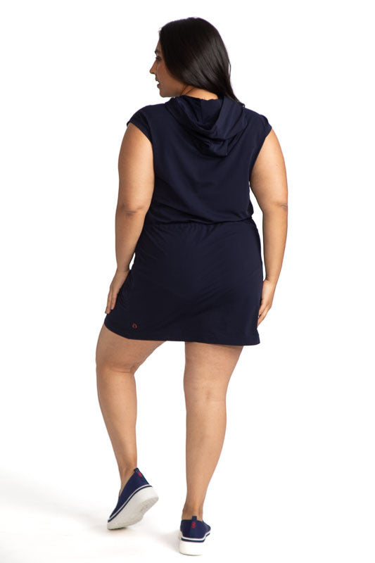 Full back view of the Aprés 18 Hoodie Dress in navy blue. This dress features a hoodie with adjustable strings for the hood in contrasting white and two front pockets