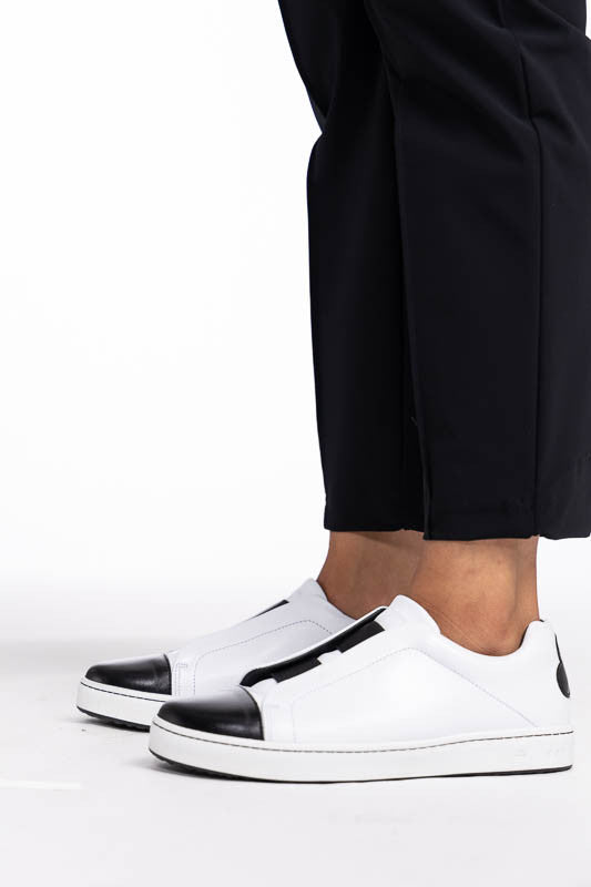 Close left side view of the hemline on the Tailored Crop Golf Pants in black.
