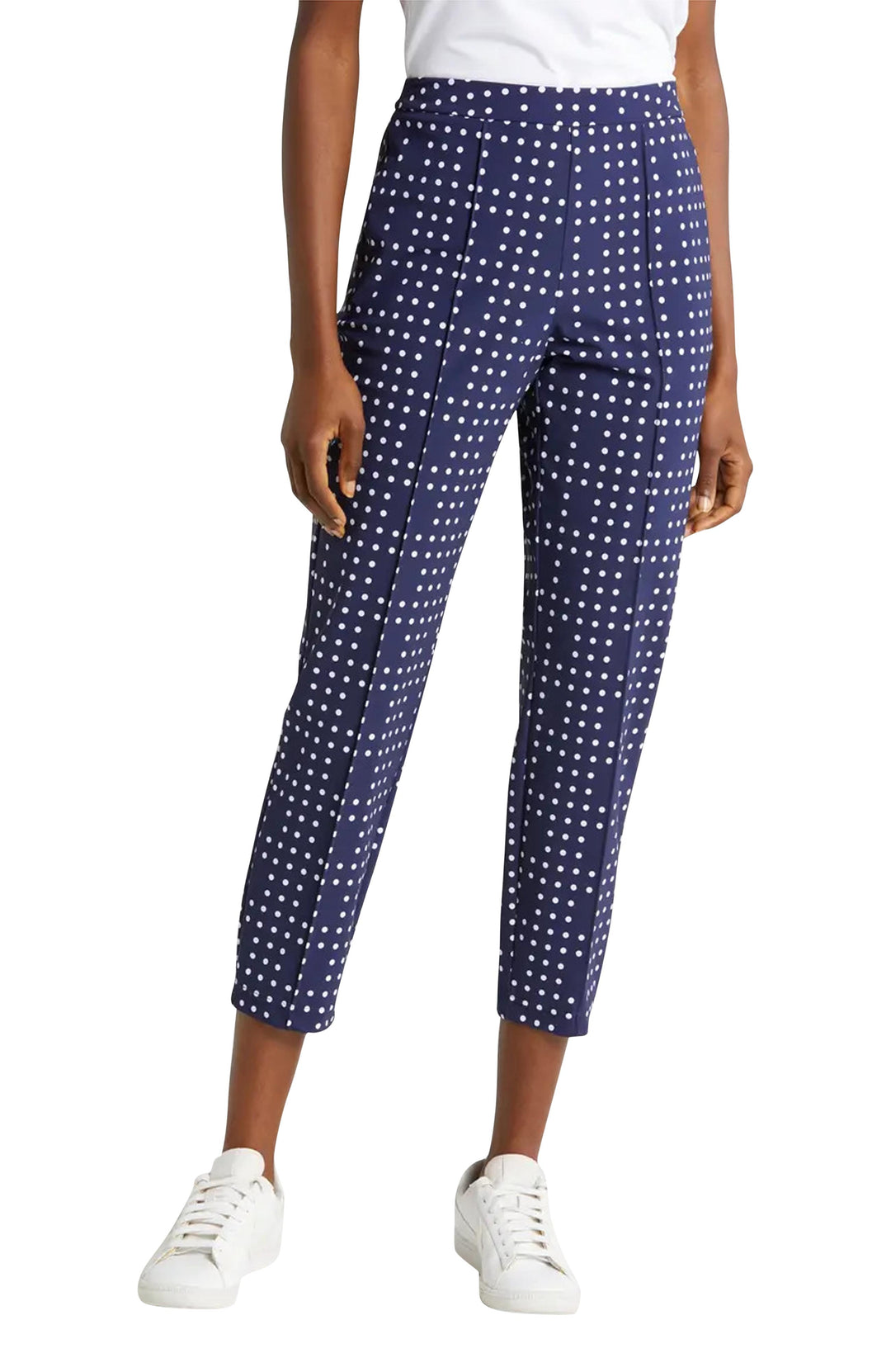 Woman wearing navy polka dot crop golf pants