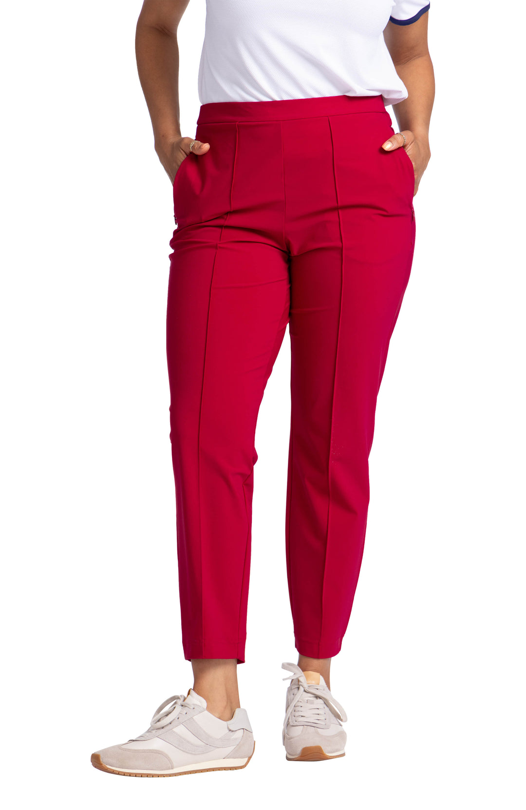 A woman wearing red, ankle length, cropped pants with a seam down the center of the pant.