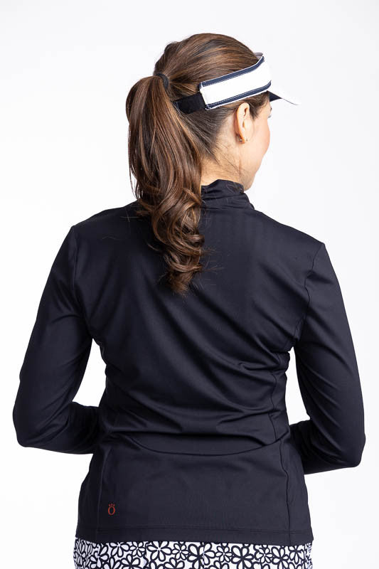 Back view of the Lovely Layer Long Sleeve Golf Top in Black and the No Hat Hair Visor in white.