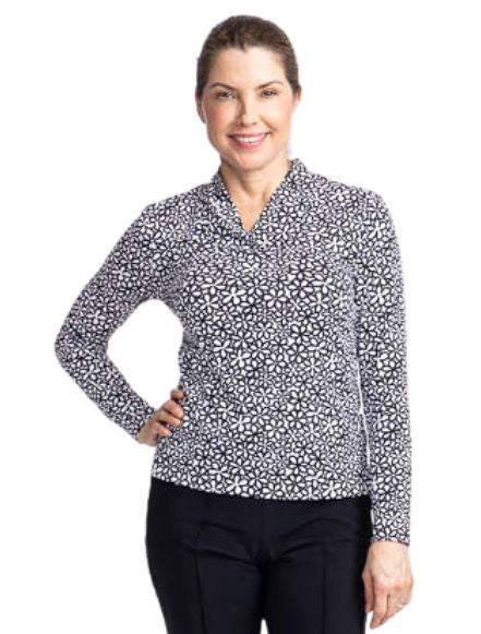 Front view of a smiling woman wearing the Lovely Layer Long Sleeve Golf Top in Fall Bloom print.