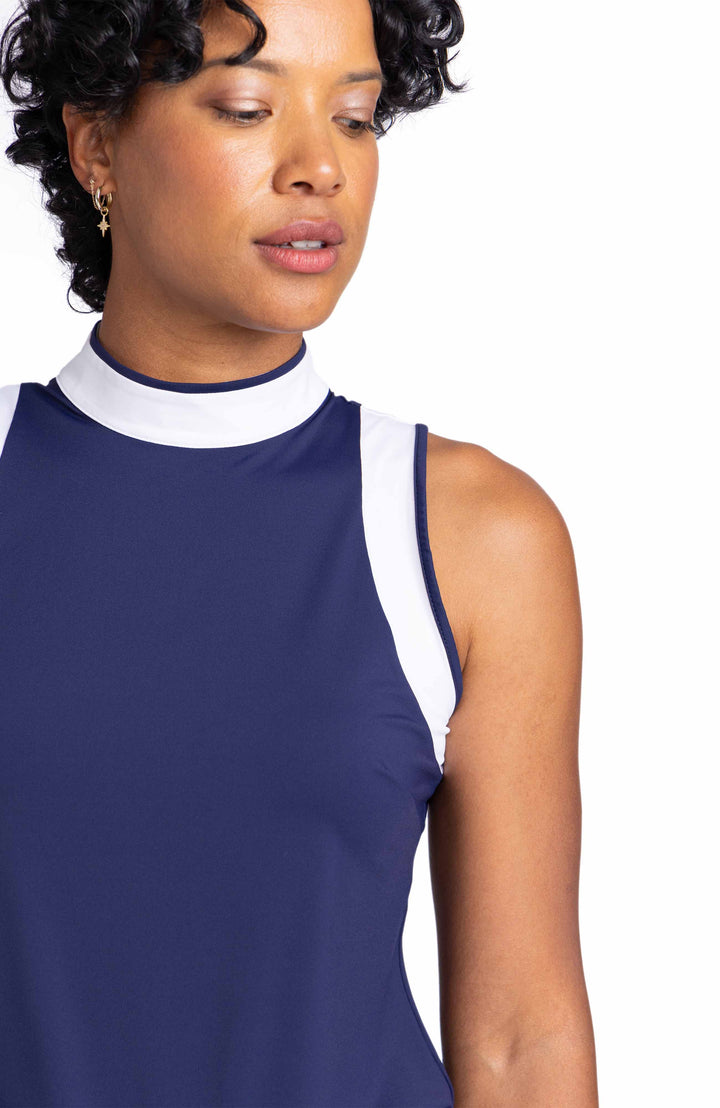 Close detailed view of the contrasting white panels on the collar and armholes of the Knock Out top in navy blue.