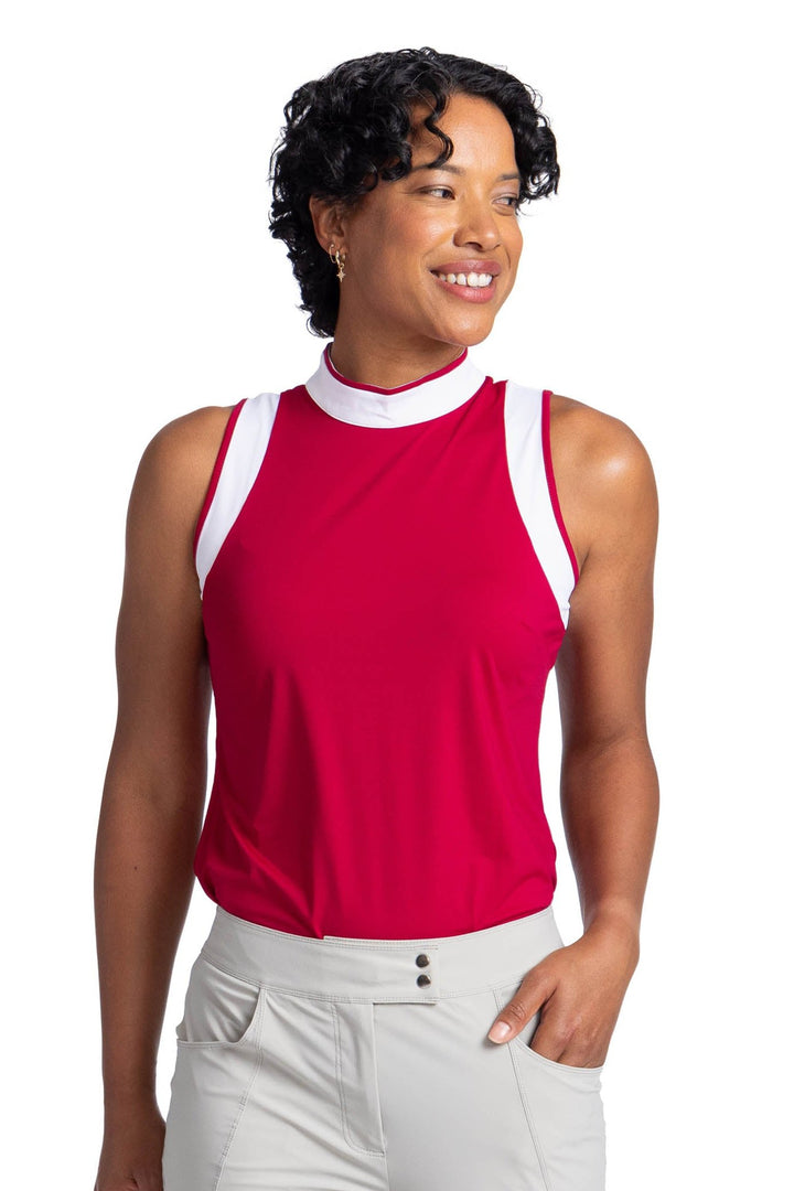 Front view of a woman wearing the Knock Out top in Bordeaux Red; the top has contrasting white panels around the armholes and on the collar. 