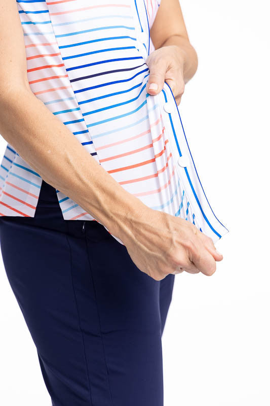 Close front and right side view of the hemline and stretchability of the fabric on the Tough in the Rough Short Sleeve Golf Top in Sun Stripe print. The Sun Stripe print consists of a mix of horizontal and vertical stripes in coral red, pacific blue, and 