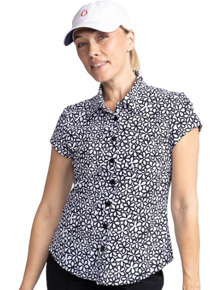 Close front view of a woman wearing the Tough in the Rough Short Sleeve Golf Top in Fall Bloom print and the We've Got You Covered Hat in white.