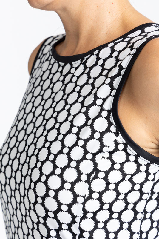 Close front and left side view of the neckline on the On In Two Sleeveless Golf Dress in Spiral Floral print. This is a retro style black and white print with a large, solid black section at the base of the dress.