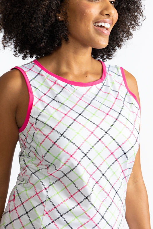 Close front view of the neckline on the On In Two Sleeveless Golf Dress in Tattersall Plaid. This dress has preppy pink trim around the neckline and each armhole. The print consists of overlapping stripes of Preppy pink, Fairway green, and black on a whit