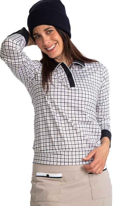 Front view of a smiling woman golfer wearing a black knit cap and the Cool and Covered Long Sleeve Golf Top in Quad Squad.